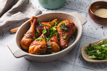 Chicken drumsticks with sesame seeds, Asian cooked chicken on the table - obrazy, fototapety, plakaty