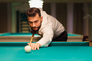 Billiard adult bearded man player at billard table or snooker american billiards pool sport game