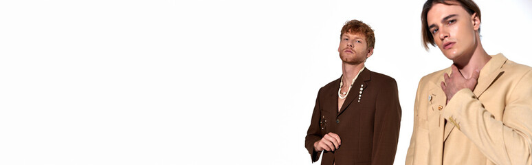 attractive young men in elegant sexy suits looking straight at camera, fashion concept, banner