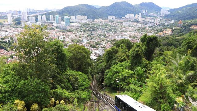 Funicular going to the top station in Penang Hill with George Town aerial view, Malaysia