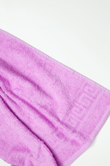 Soft and fluffy bath towel on white background. Top view, flatlay, copy space