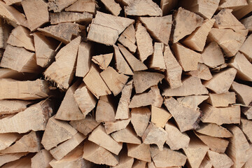 Stack of firewood. Chopped logs background. Woodpile background. Stacked wood. Wooden texture. Logging storage. Harwood background. Pile of firewood. Preparation for winter.