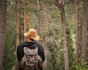 person in a forest with hat