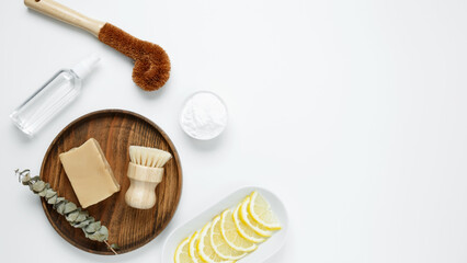 Eco friendly cleaning concept. Brushes made from natural materials, soda, soap, vinegar, lemon for cleaning and washing house. Top view, copy space, flatlay