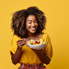 Black woman eating a healthy bowl of fruit. - obrazy, fototapety, plakaty