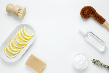Eco friendly cleaning concept. Brushes made from natural materials, soda, soap, vinegar, lemon for cleaning and washing house. Top view, copy space, flatlay