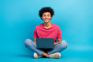 Full body photo of handsome young male sit floor folded legs working laptop dressed stylish pink...