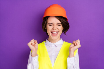 Photo of hooray nice brunette hair lady hands fists wear builder uniform isolated on purple color background