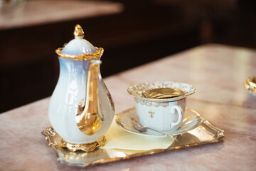 Obraz na płótnie Canvas Pouring hot herbal tea into cup