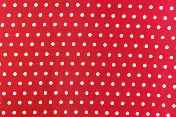 texture of red silk or polyester fabric with white polka dots. background for your design