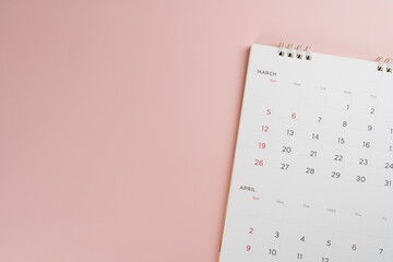 close up of calendar on the pink table background, planning for business meeting or travel planning concept - obrazy, fototapety, plakaty