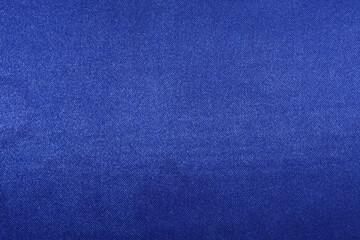 texture of deep blue fabric with glare close-up. background for your design. material for sewing...