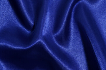 close-up texture of deep blue fabric with glare crumpled and wrinkled. background for your design. material for sewing