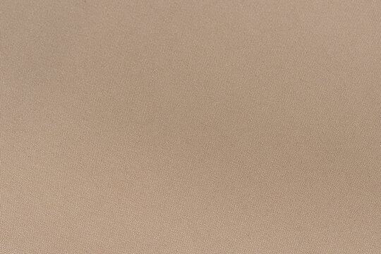 Close-up texture of pink polyester twill fabric. Background for your mockup. Sewing material