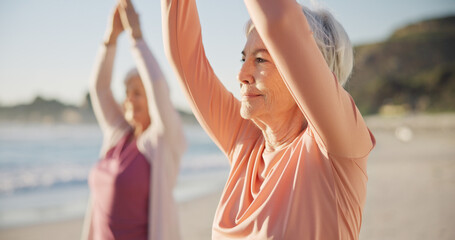 Yoga, meditation and senior women, stretching and fitness on beach for wellness, exercise and...