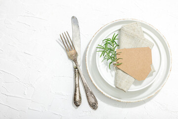 Minimalist table setting. Elegant cutlery, traditional zero waste props. Festive empty dishes