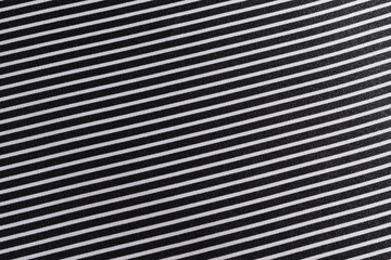 close-up texture of black and white striped silk fabric at an angle. Tailoring concept. Image for...