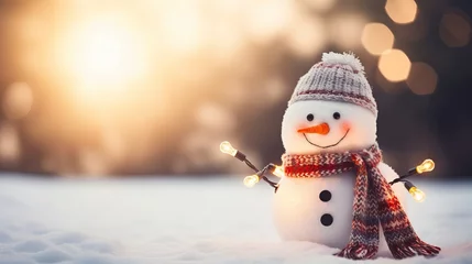 Poster Snowman with hat and scarf on snowy background with bokeh lights and sun rays with copy space - Winter holiday Christmas banner © Ameer