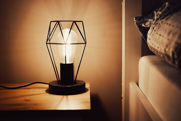 Night retro lamp near bed. Dim light in the room. Lantern illumination. Healthy night sleep...