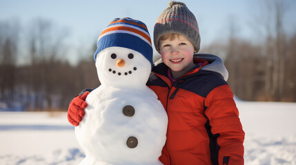 Portrait of cute boy posing around cheerful funny snowman in winter park outdoors
