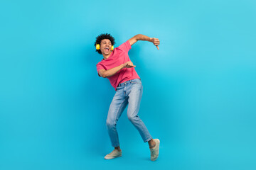Fototapeta na wymiar Full body photo of handsome young male dancer earphones have fun wear trendy pink outfit isolated on blue color background