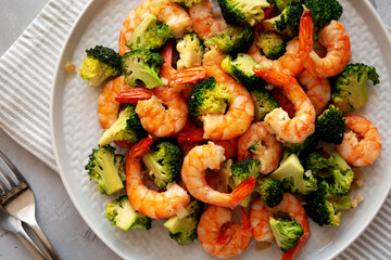 Homemade Garlic Broccoli Shrimp Stir Fry on a Plate, top view. Flat lay, overhead, from above. Close-up.