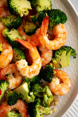 Homemade Garlic Broccoli Shrimp Stir Fry on a Plate, top view. Flat lay, overhead, from above. Close-up.