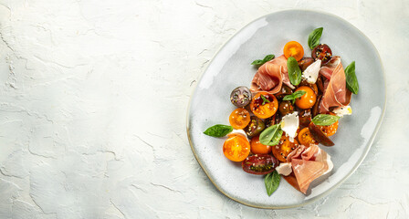 Salad with Prosciutto, ham jamon and cherry tomatoes, Long banner format. top view