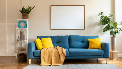 blue sofa with yellow pillows and blanket against beige wall with frame poster scandinavian