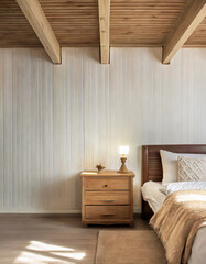 Wood bedside cabinet near bed with beige blanket Farmhouse interior design of modern bedroom with lining wall and beam ceiling