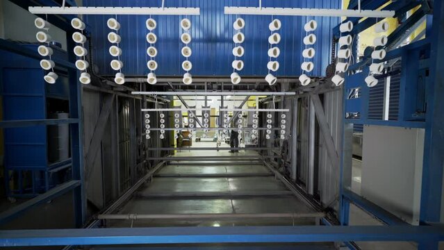 A Lot Of Light Sockets Hang In Large Drying Machine At Conveyor Line On Manufacturing Plant. Drying Process At Production Factory. Modern Conveyor Line Equipment. Details At Drying Conveyor Line.