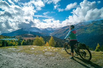 Italy, Southern Tyrol, Vinschgau, mountainbiker in front of autumn landscape