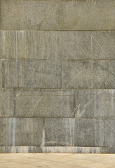The texture of a wall of large granite tiles that are covered with white streaks when exposed to...