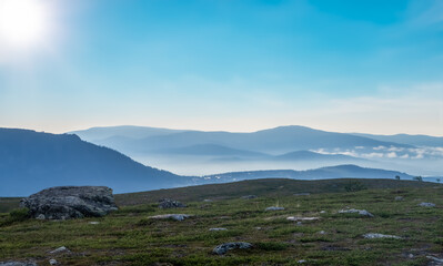 Early in the morning up in the mountains of T&auml;nndalen in Sweden. A beautiful blue sky and morning mist still lingering down in the valley.