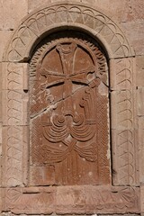 a carved piece of stone with an image of a woman