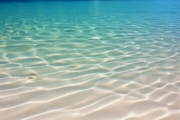 Fototapeta na wymiar Rippled sand under crystal-clear ocean water