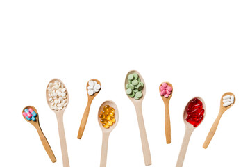 Top view Variety of vitamin and mineral pills in wooden spoon on Colored background. Top view of assorted pharmaceutical medicine pills. Dietary supplement healthcare product