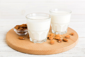 Set or collection of various vegan milk almond, cashew, on table background. Vegan plant based milk and ingredients, top view