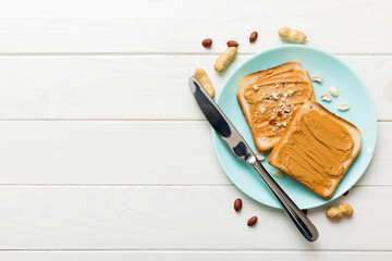 Peanut butter sandwiches or toasts on light table background.Breakfast. Vegetarian food. American cuisine top view vith copy space