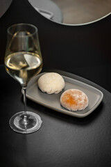 Traditional Japanese dessert mochi and a glass of white wine