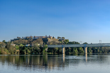 Fototapeta premium View of the Valença de Minho fortress reflecting in the river and the International Iron Bridge. Portugal.