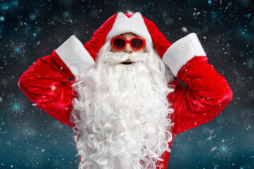Excited funny man wearing Santa Claus costume, stylish glasses holding head looking at camera...