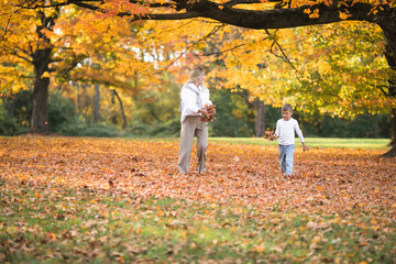 Fototapeta premium Mothers day, love family. Family on autumn walk in nature outdoors. Mother and child with hugging tenderness