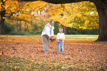 Mothers day, love family.  Family on autumn walk in nature outdoors. Mother and child with hugging tenderness