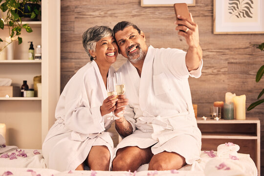 Couple, selfie and champagne toast for spa massage, vacation or holiday celebration, love and social media. Wine glasses of excited senior people in profile picture at hotel for luxury or hospitality