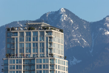 Naklejka premium Apartment buildings and condominiums in Vancouver with snow capped mountains in the background. 