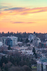 Fototapeta premium Colorful soft warm light over an urban cityscape with apartment buildings and tall high rises - Vancouver British Columbia