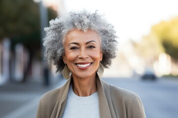 Close up portrait of beautiful Mature black woman smiling outdoors. African American lady walking on the street, smiling, wearing stylish look . Fashion concept  - obrazy, fototapety, plakaty