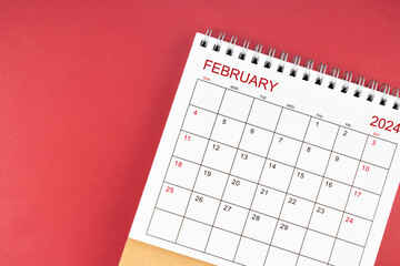 February 2024 desk calendar on red color.