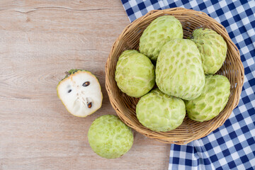 Ripe of custard apple in wooden basket.